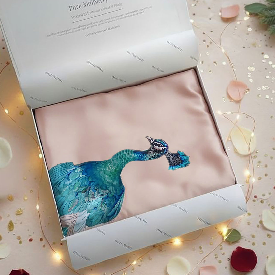Silk pillowcase with peacock design in a decorative box on a festive background