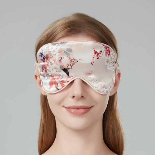 Woman wearing a floral sleep mask against a soft pink background