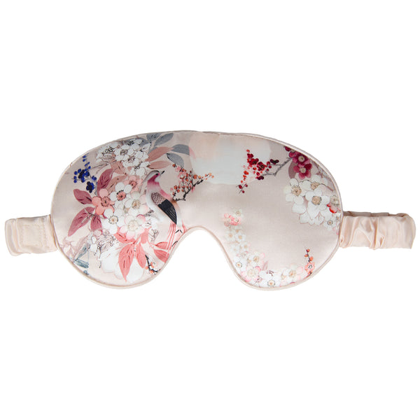 Floral patterned silk eye mask on a white background